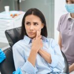 Anxious client complaining to stomatologist on sharp and sudden pain