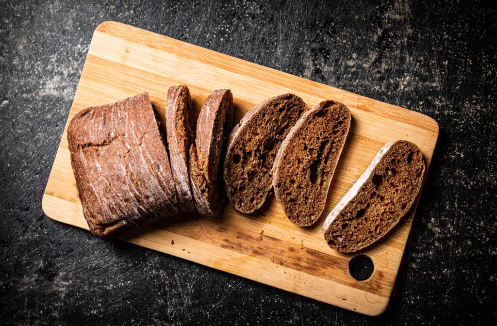 Sliced rye bread on a cutting board.